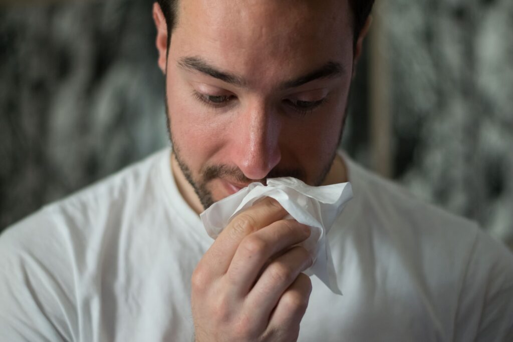 Man wiping mouse with tissue paper