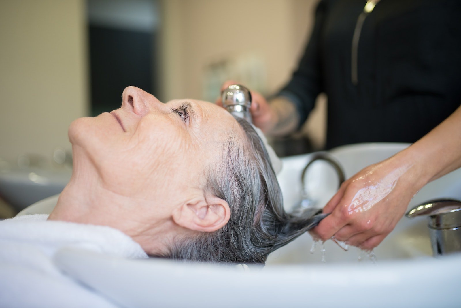 Woman getting a hair washed on a salon