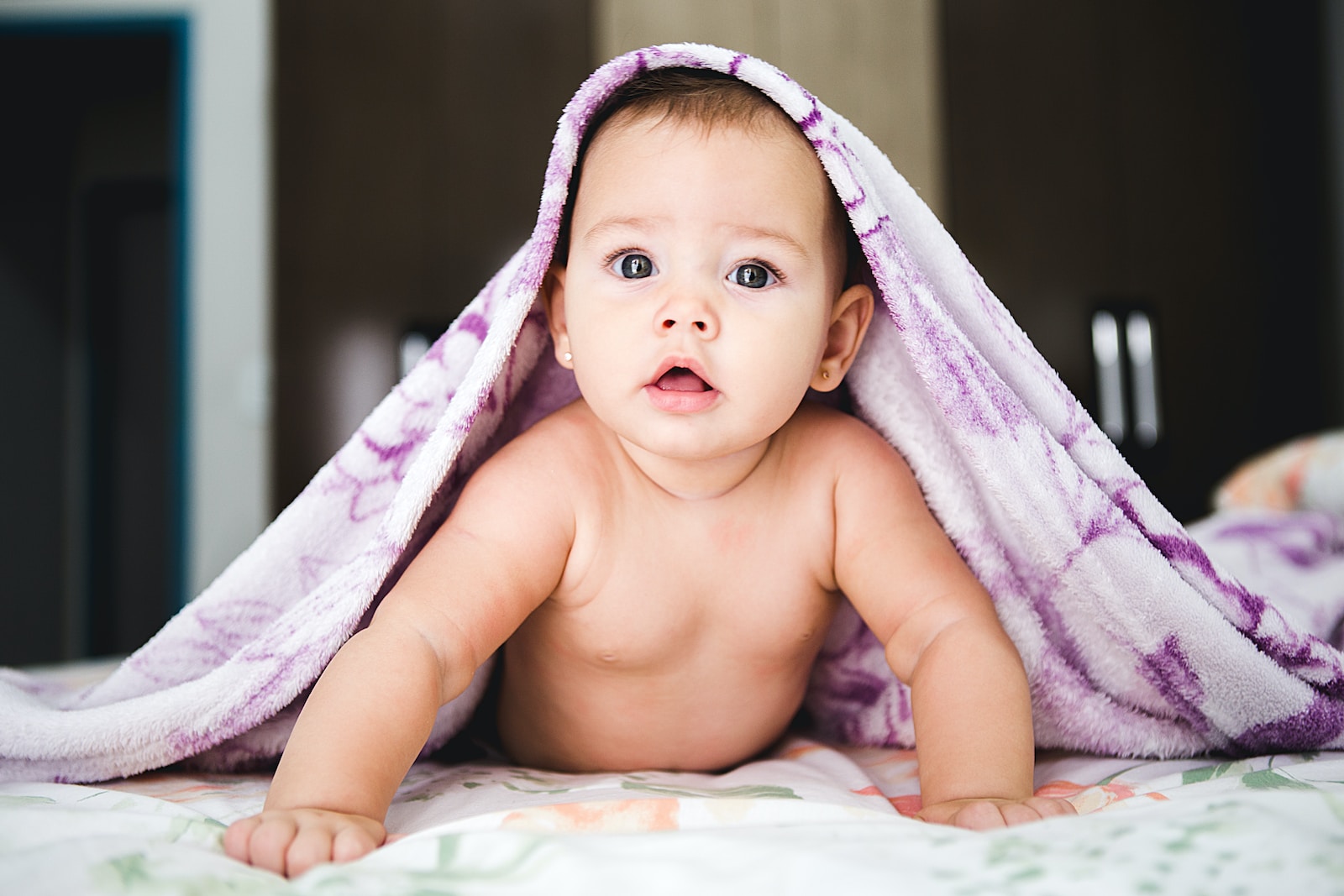 Baby under purple blanket