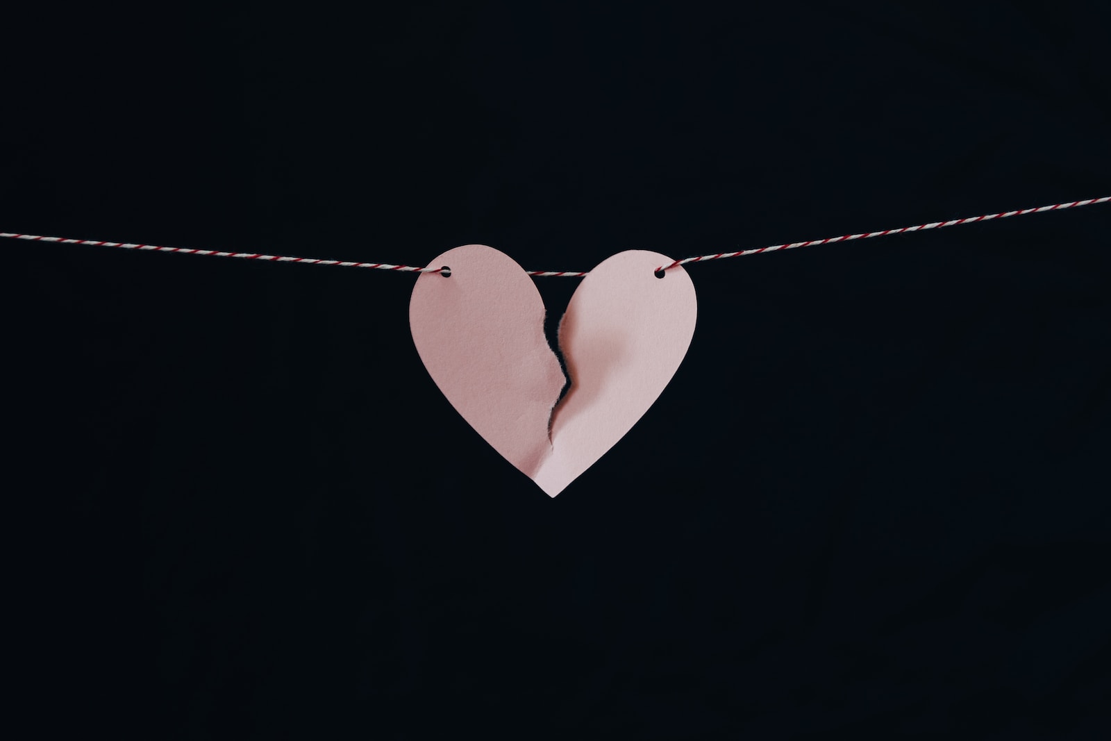 Broken heart hanging on wire