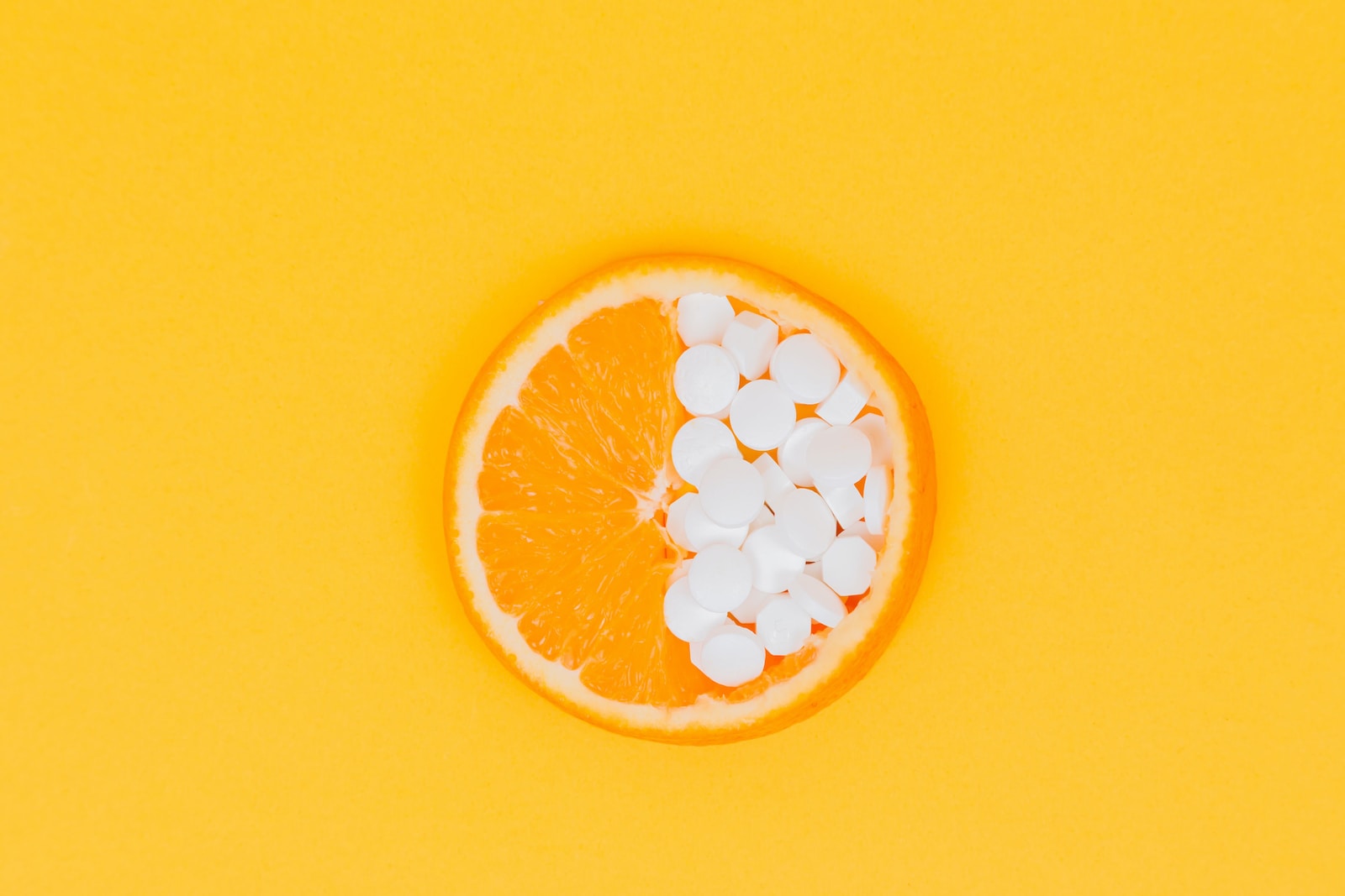 Orange fruit slices on yellow surface