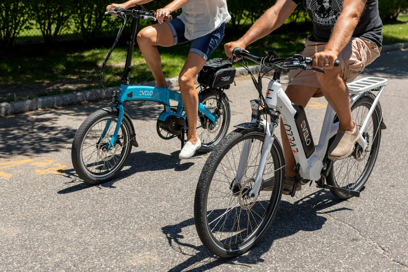 Two people riding electric bicycles