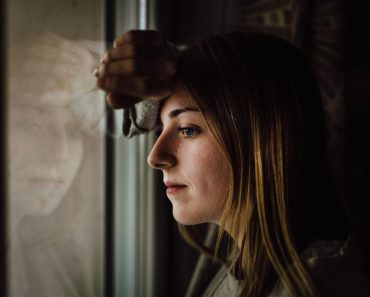 Woman Leaning on Glass Window