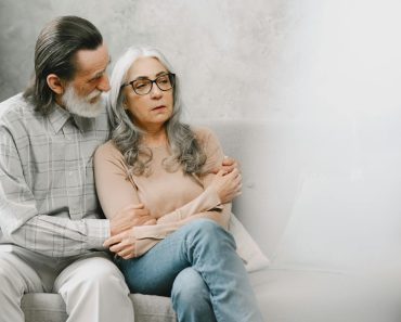 Bothered Elderly Woman being comforted by her Spouse