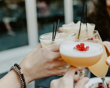 person holding filled drinking glasses