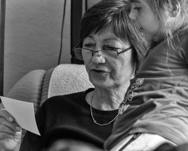 a woman and a little girl sitting on a couch