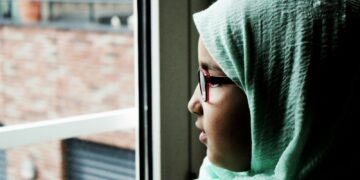 woman looking outside of the window during daytime