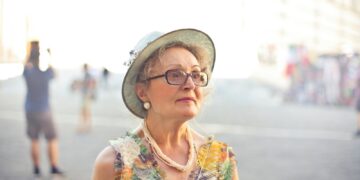 Depth of Field Photography of Woman in Pastel Color Sleeveless Shirt and White Sunhat