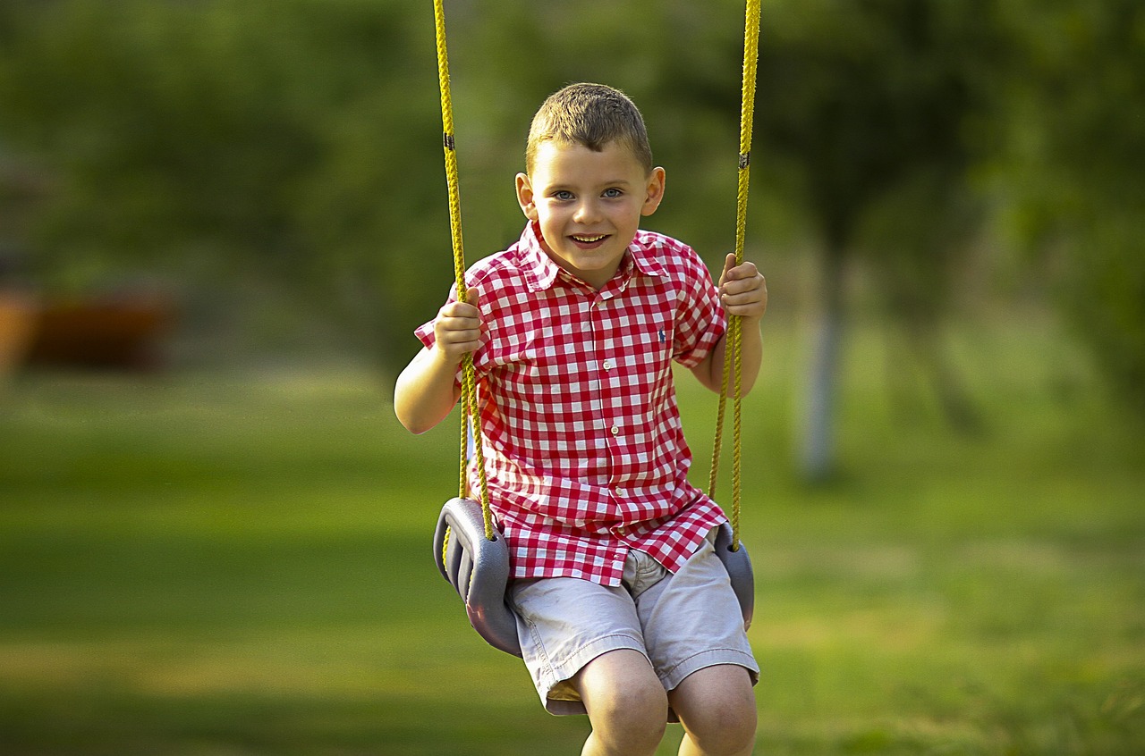 Boy swinging playing