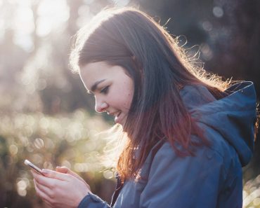 woman holding phone smiling