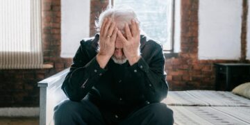 Man in Black Jacket Covering Face