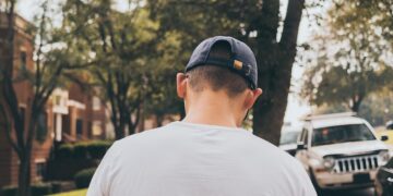 man walking in sidewalk