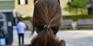 woman in black jacket with brown hair