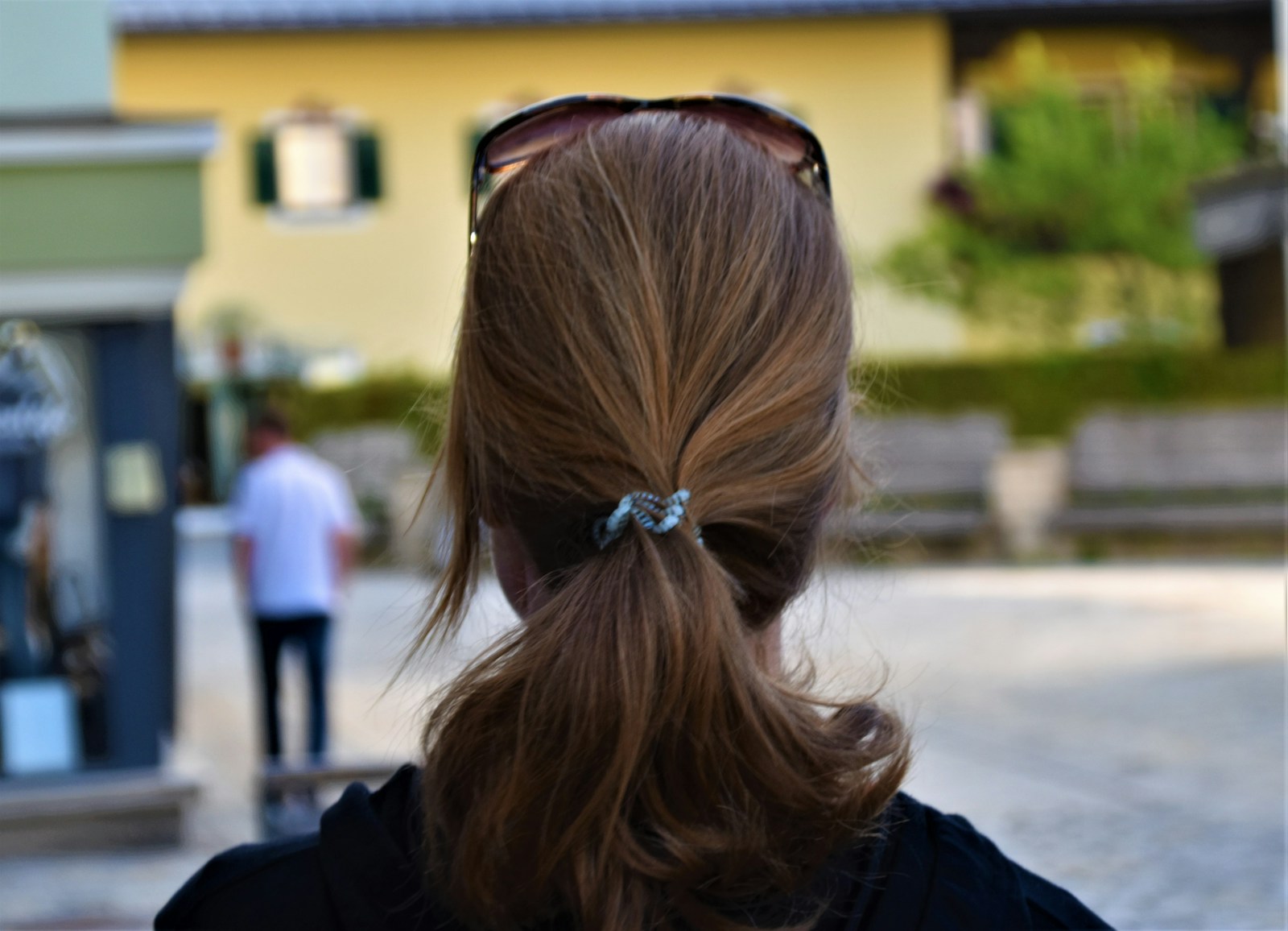 Woman in black jacket with brown hair