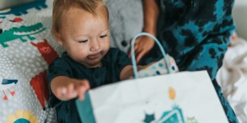girl in red crew neck t-shirt holding white paper