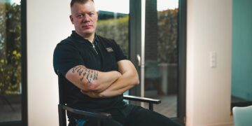 a man sitting in a chair with his arms crossed