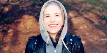 woman smiling near tree