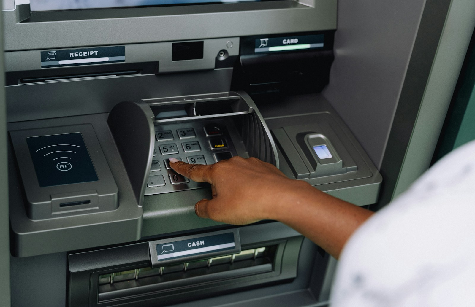 A person using an atm machine to pay money