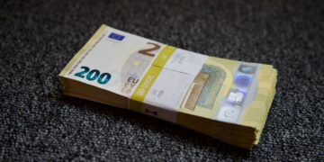 a stack of money sitting on top of a carpet