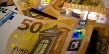 a pile of 50 euro bills sitting on top of each other