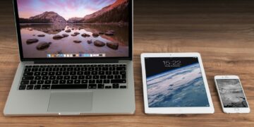 MacBook Pro beside iPad and iPhone turned on