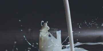 white candle in clear glass holder