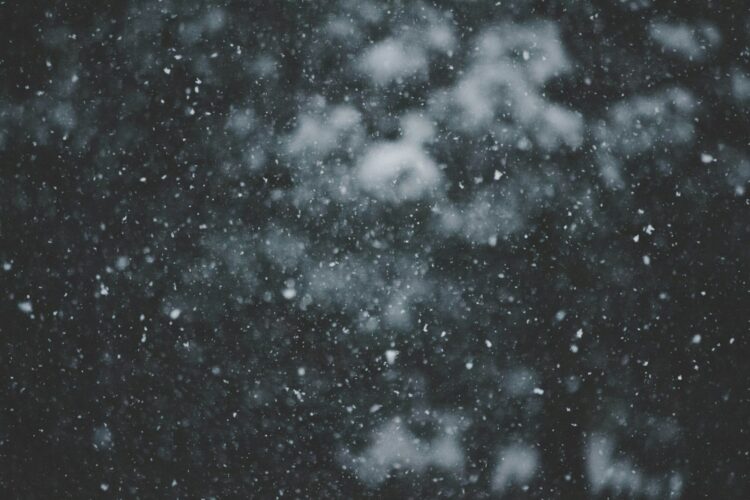 A black and white photo of snow falling