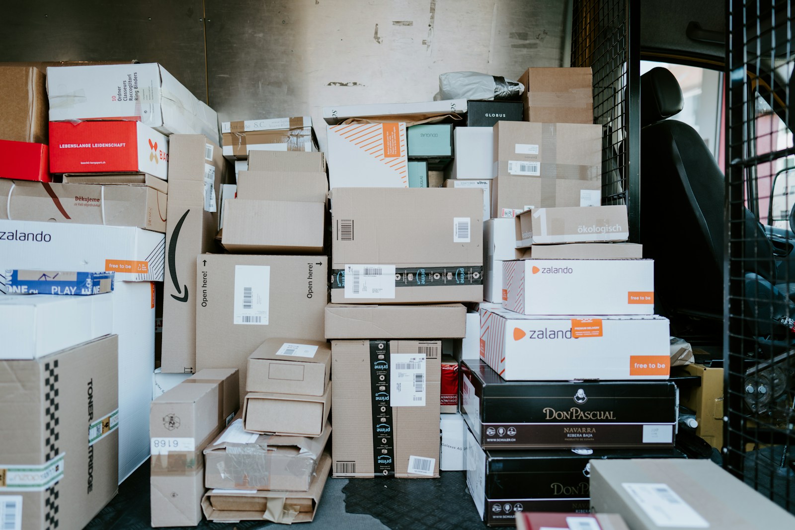 Brown cardboard boxes on black plastic crate