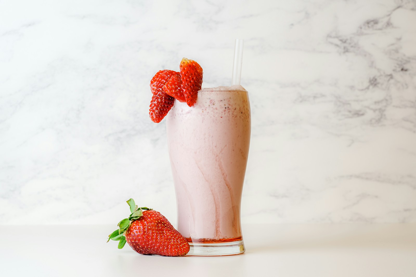 Strawberry shake in clear drinking glass