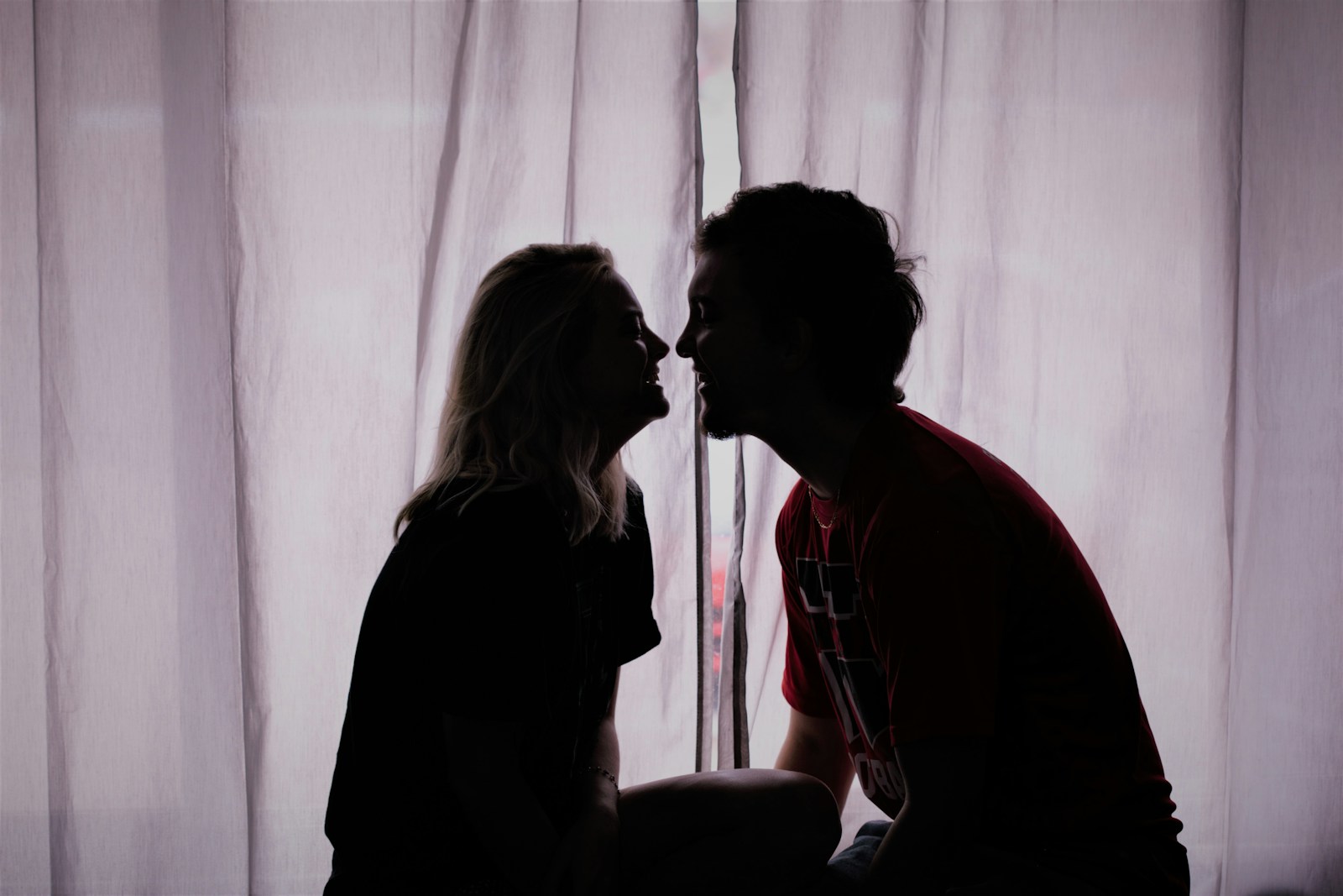 Silhouette photo of woman and man close to each other