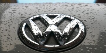 water dew on silver Volkswagen car emblem
