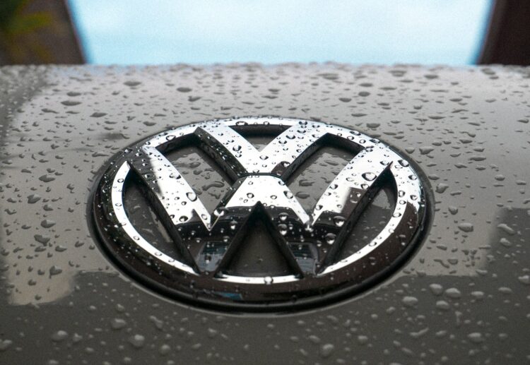 Water dew on silver volkswagen car emblem