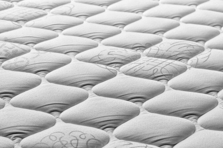 A close up of a mattress that has been made