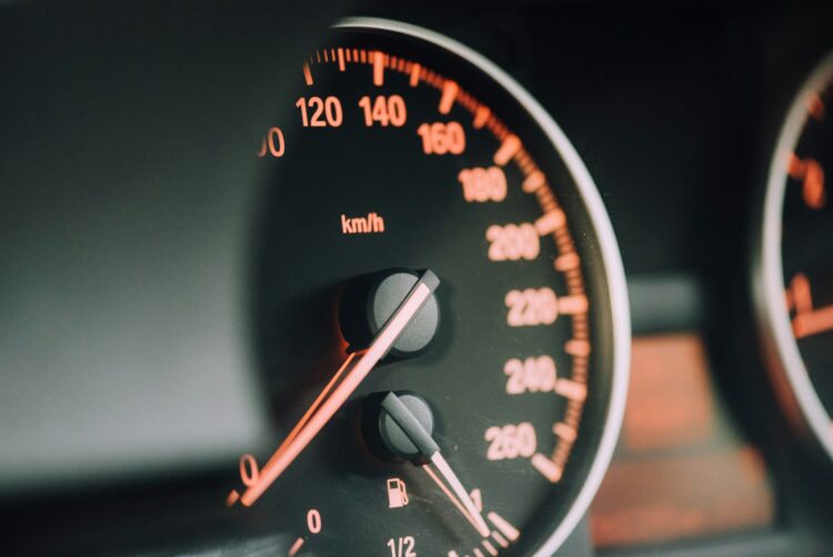 Closeup photo of black analog speedometer