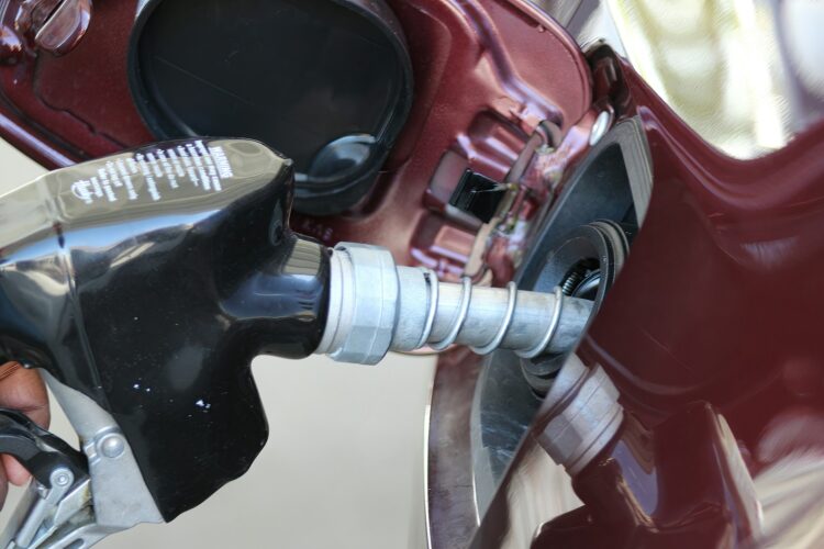 A close up of a person holding a gas pump
