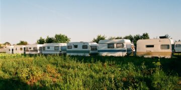a group of rvs are parked in a field