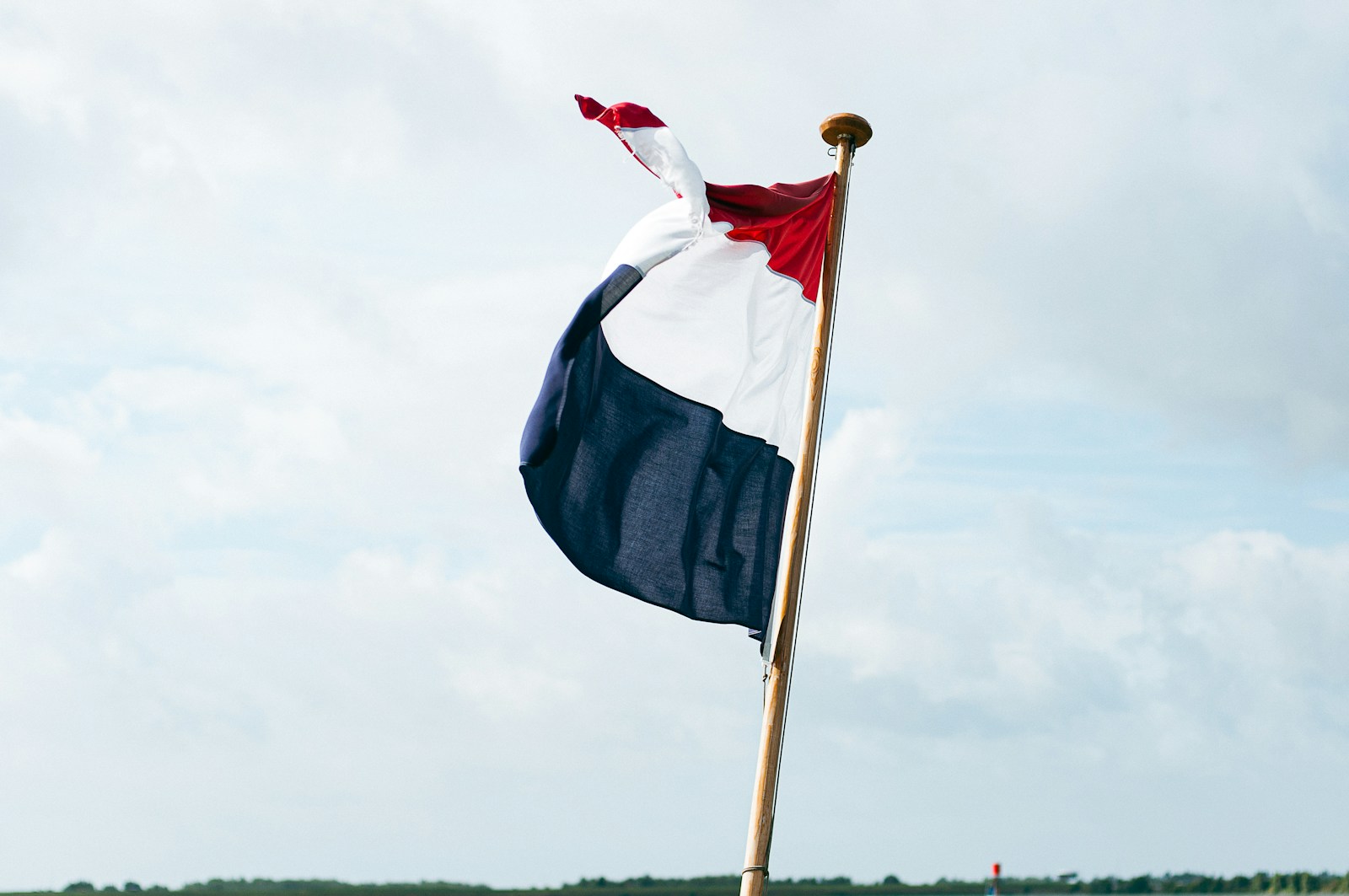 Flag of us a on pole under white clouds
