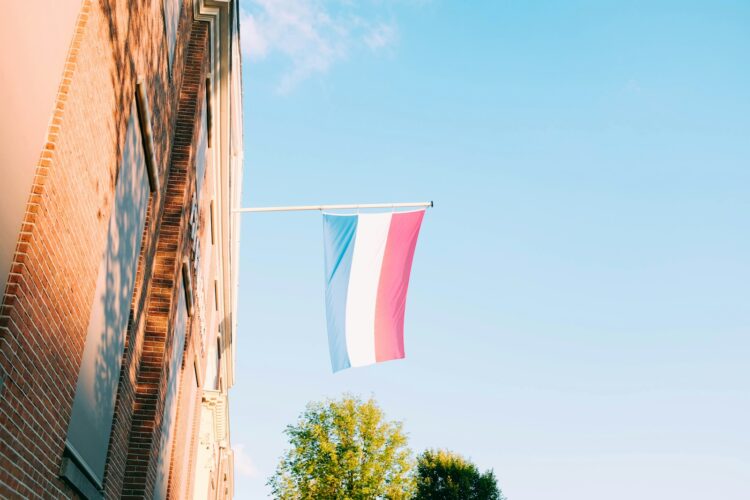 Red white and blue flag hanging on window