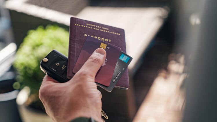 Person holding black and brown book