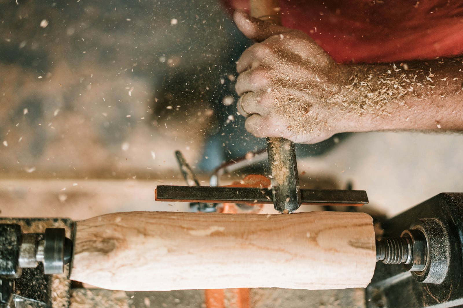 Person holding gray metal tool