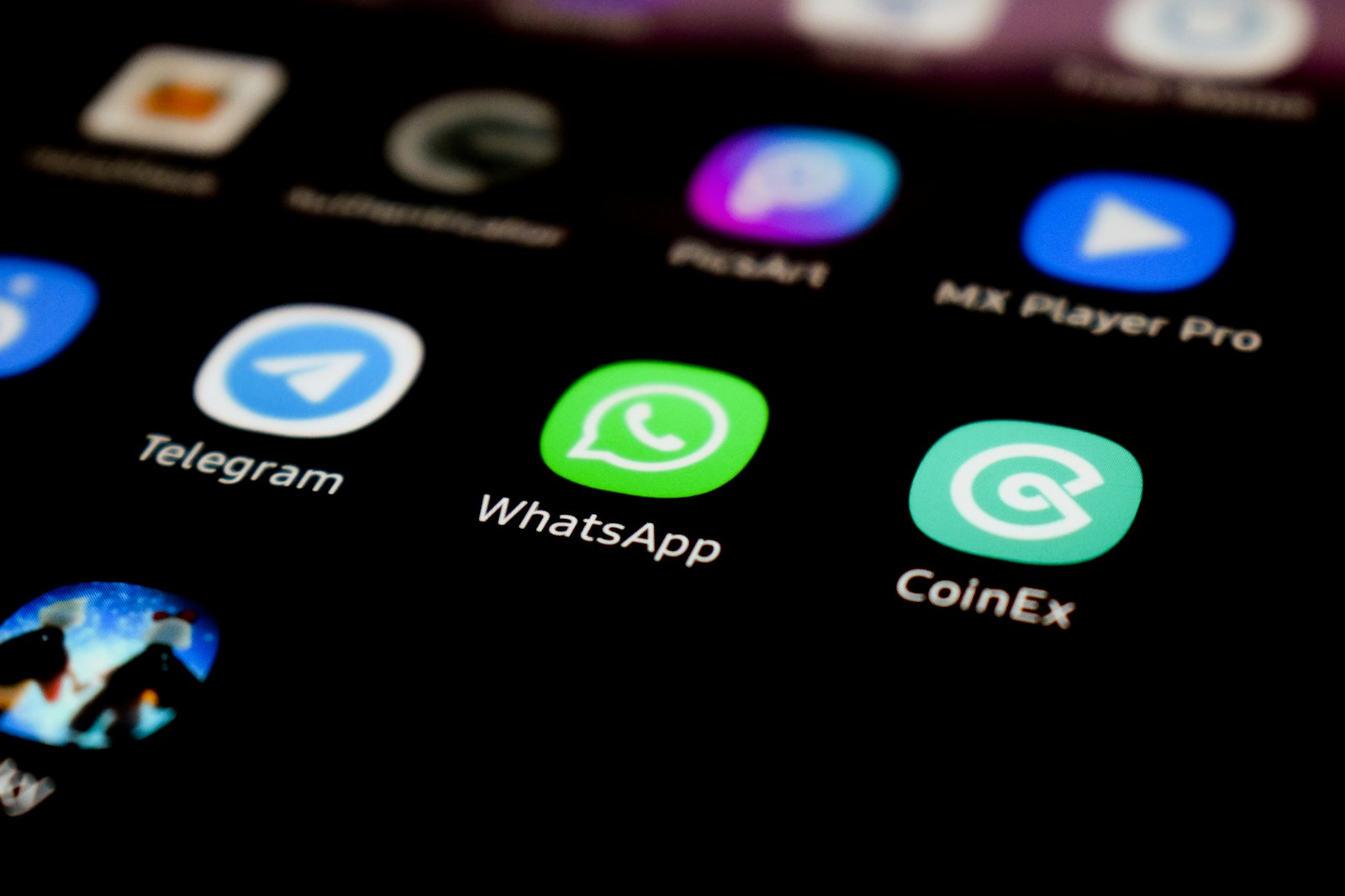 A close up of a cell phone with whatsapp on the screen
