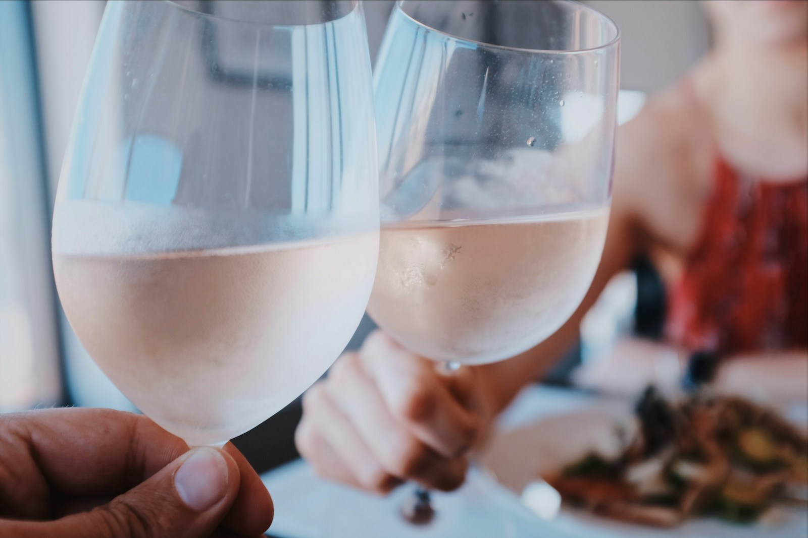 Two person toasting wine glass cups