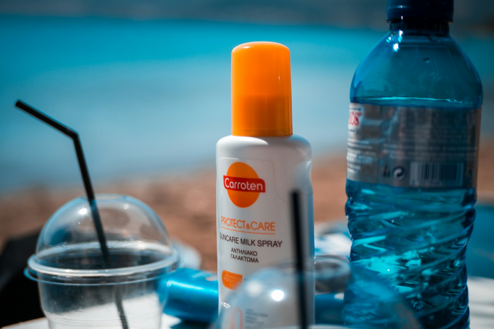 White and orange plastic bottle on blue table