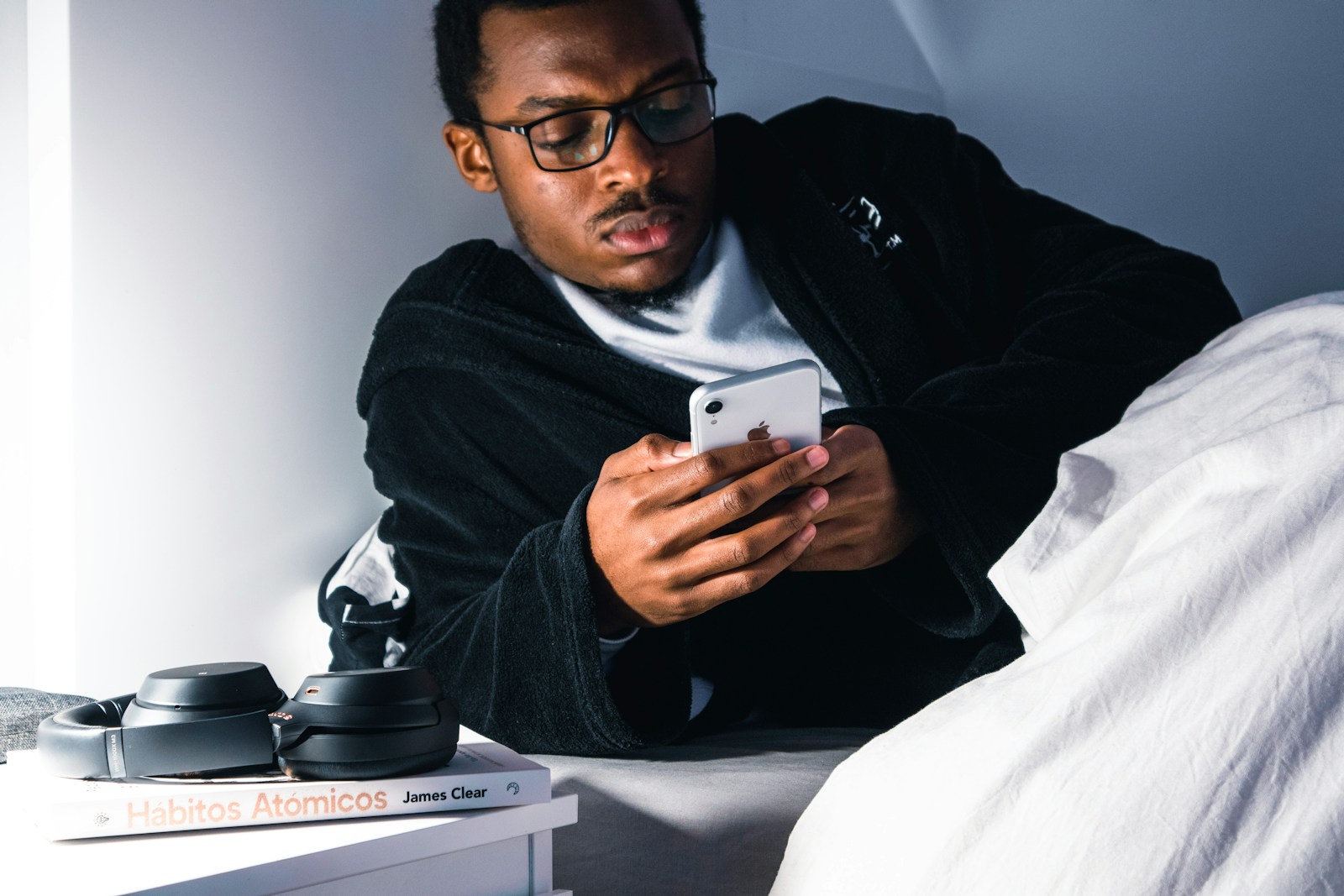 Man in black jacket wearing black framed eyeglasses