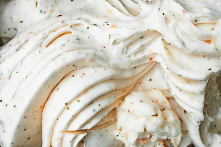 Delicious creamy vanilla ice cream with textured swirls and flecks captured in a close up view