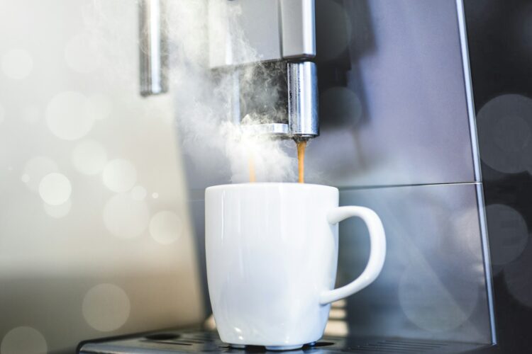 White coffee mug on coffeemaker