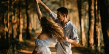 man and woman dancing at center of trees