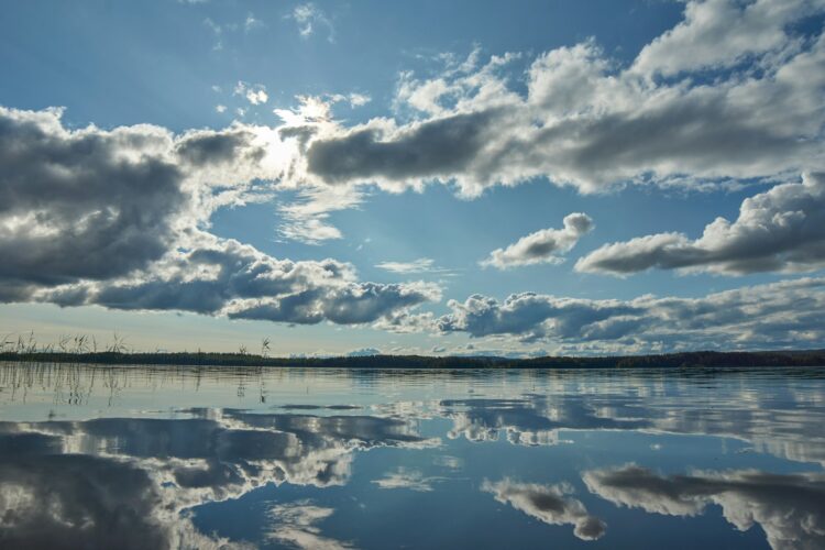 Blue sky and white clouds over lake