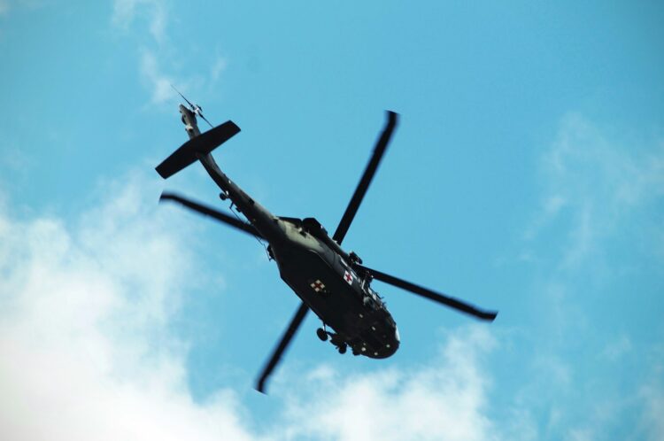 Low angle photo of black and green helicopter