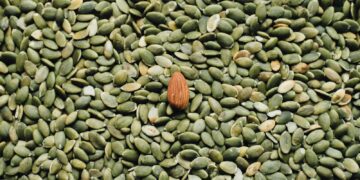 almond seed on top of green seeds